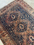Close-up of tribal medallion with geometric detailing and soft wear.