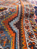 Vegetable-dyed wool Persian rug with a rich tribal palette and authentic antique patina.