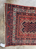 Decorative vintage runner rug with intricate patterns on a concrete floor