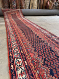 angle full length of vintage Persian Malayer runner rug field detail showing pistachio green and rust red boteh motifs