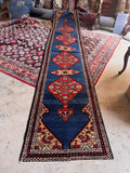 Long narrow Persian runner under three feet wide with French blue field.