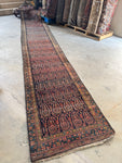 Antique Persian runner with colorful outlined paisleys from the 1920s.