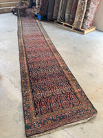 Antique Persian runner with colorful outlined paisleys from the 1920s.