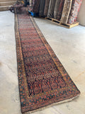 Antique Persian runner with colorful outlined paisleys from the 1920s.