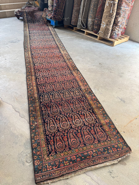 Antique Persian runner with colorful outlined paisleys from the 1920s.