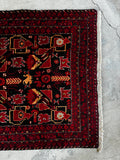 Vibrant black red Persian rug 3x6 close up of peacock and bird motifs in saturated red and gold