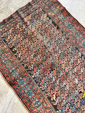 Hand knotted Persian scatter rug with authentic age, professionally restored antique wool rug in faded coral and denim blue tones.
