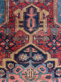 Small Persian Heriz rug. Antique wool area rug with a geometric medallion, tribal motifs, and naturally aged vegetable-dyed wool.
