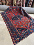 Vintage Persian area rug with geometric tribal motifs and floral details, hand knotted wool Malayer rug.