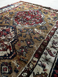 Antique Caucasian wool rug with symbolic geometric motifs