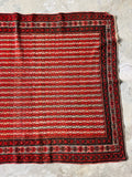 Rustic low pile antique Persian rug showing authentic scattered wear and character.