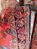 Coral antique rug with navy floral border and mini coral heart guard borders.