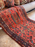 Coral watermelon Persian Malayer rug with rich sky blue and navy accent borders.