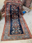 Antique 1920s Persian Malayer rug with botanical column motifs on a deep navy blue ground.