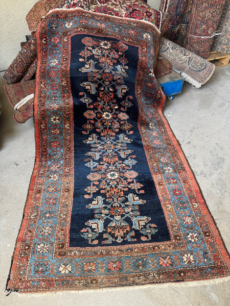 Antique 1920s Persian Malayer rug with botanical column motifs on a deep navy blue ground.