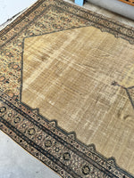 Restored Persian rug with low pile and visible age