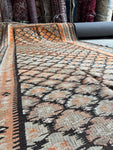 Antique runner in mellowed dyes with pops of tangerine.