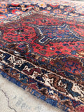 1940s vintage Persian rug with berry, blue, ivory, light camel, and chestnut brown details.