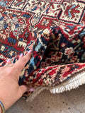 Soft wool Persian rug detail displaying plush pile texture and hand-knotted tribal motifs.