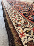 Ivory botanical border Persian rug close-up view highlighting the detailed floral border pattern encircling the main field.