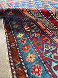 Antique small size Caucasian rug handwoven with glowing wool.