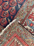 Underside view of animal motif Persian runner rug with peacocks and traditional paisley designs.