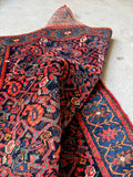 View showing hand knotted Persian wool rug with vibrant colors.
