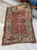 Antique 19th century Persian Sultanabad Mahal rug with worn brick red field and oatmeal border.