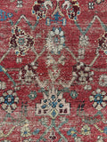 Close-up of botanical motifs and worn vegetable dyed wool on Sultanabad Mahal rug.