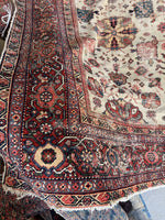 Close-up corner of a Persian rug with intricate designs.