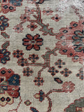 Close-up of a floral motifs with intricate details against an ivory ground.