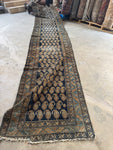Super long handwoven Persian runner with scattered wear and aged character.