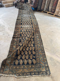Super long handwoven Persian runner with scattered wear and aged character.