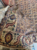 Close-up of a corner of a patterned rug with intricate designs.
