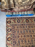 Close-up of corner showcasing elaborate botanical motifs and fine weaving.