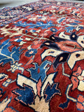Close-up of antique Tabriz rug showing fine weave and soft wool sheen.