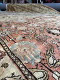 Handwoven Tabriz rug with floral and bird motif details.