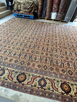 Side view of large Persian Tabriz rug on floor. 