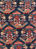 Detailed view of outlined paisley designs on a handwoven Kurdish rug.
