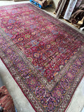Brilliantly colored antique rug with electric flower motifs