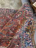 Vintage Persian Heriz area rug. Antique wool carpet featuring rectilinear tribal motifs, naturally aged vegetable dyes, and a durable low pile.