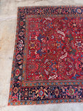 An antique Persian Heriz boho tribal rug featuring a bold edgy design.