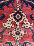 Close up of oversized antique floral rug bringing heirloom quality and rich color variation to home decor.