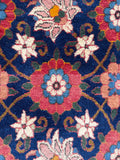 Vegetable dyed Persian rug showing deep navy blue ground with vibrant pink accents.