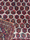 Authentic hand knotted paisley accent rug with traditional geometric border detail.