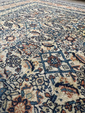 1920s vintage wool area rug featuring a dense water garden Herati field motif in soft neutral tones.