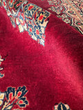 Floor ready 1930s Persian Sarouk rug close up detail of soft wool surface and natural color variations.