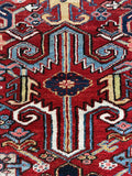 Bold graphic geometric motifs bring a tribal vibe to this antique Persian rug.