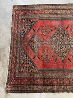 Corner of one end showing naturally aged vegetable dyes giving the rug earthy tones.