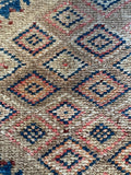 Close-up of antique runner showcasing geometric motifs within main field design.